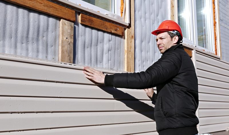 young professional fixing the windows sidings