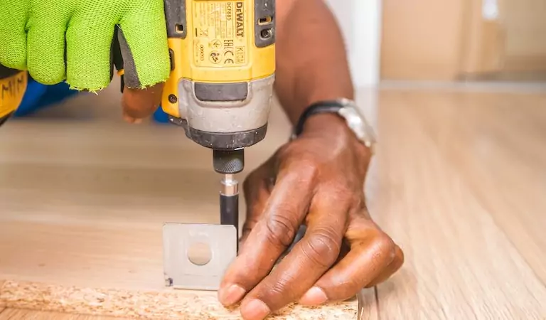 cropped picture of a person using a drill machine